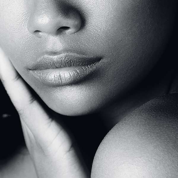 Young beautiful black girl with clean perfect skin close-up. Beauty portrait